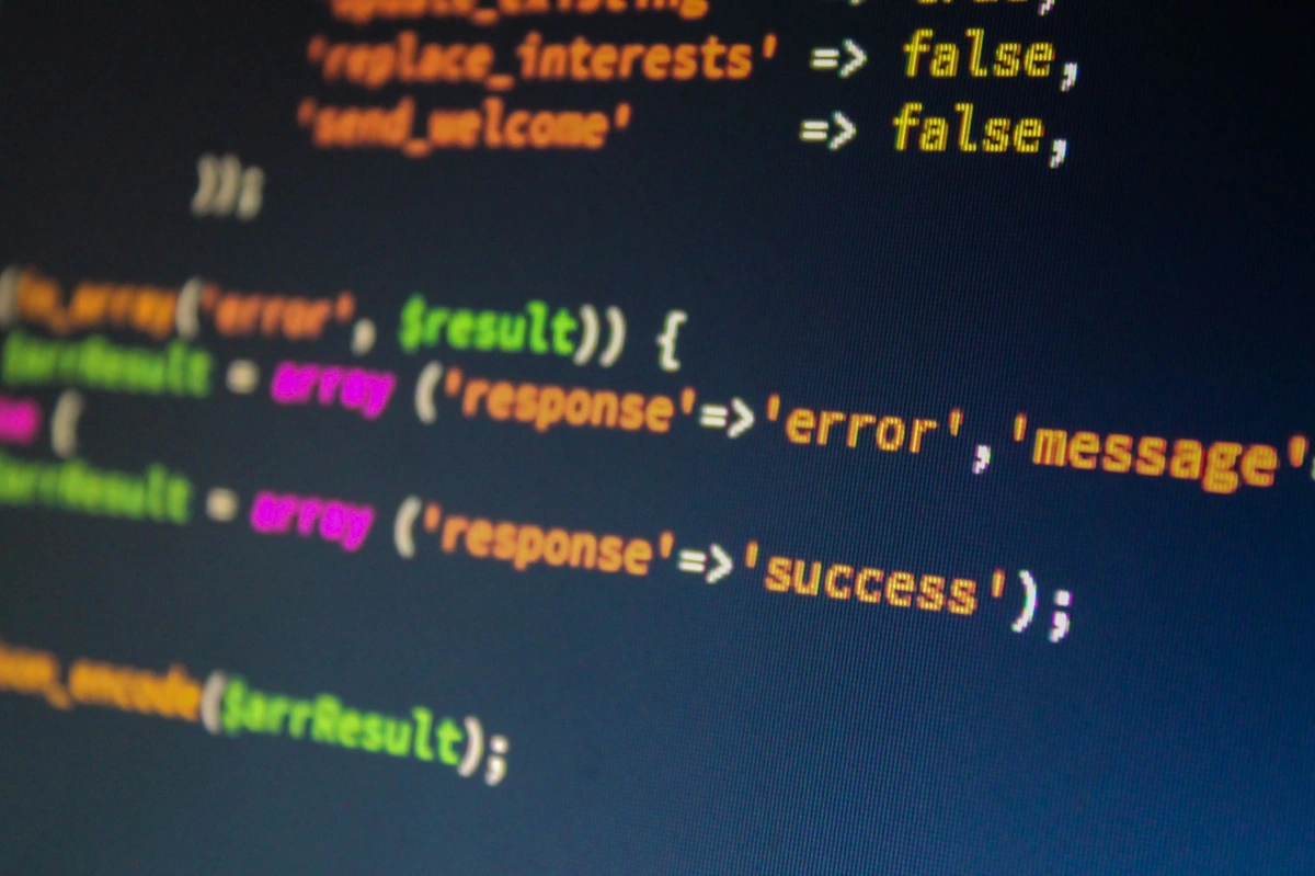 A developer desk with two monitors showing REST and GraphQL API requests